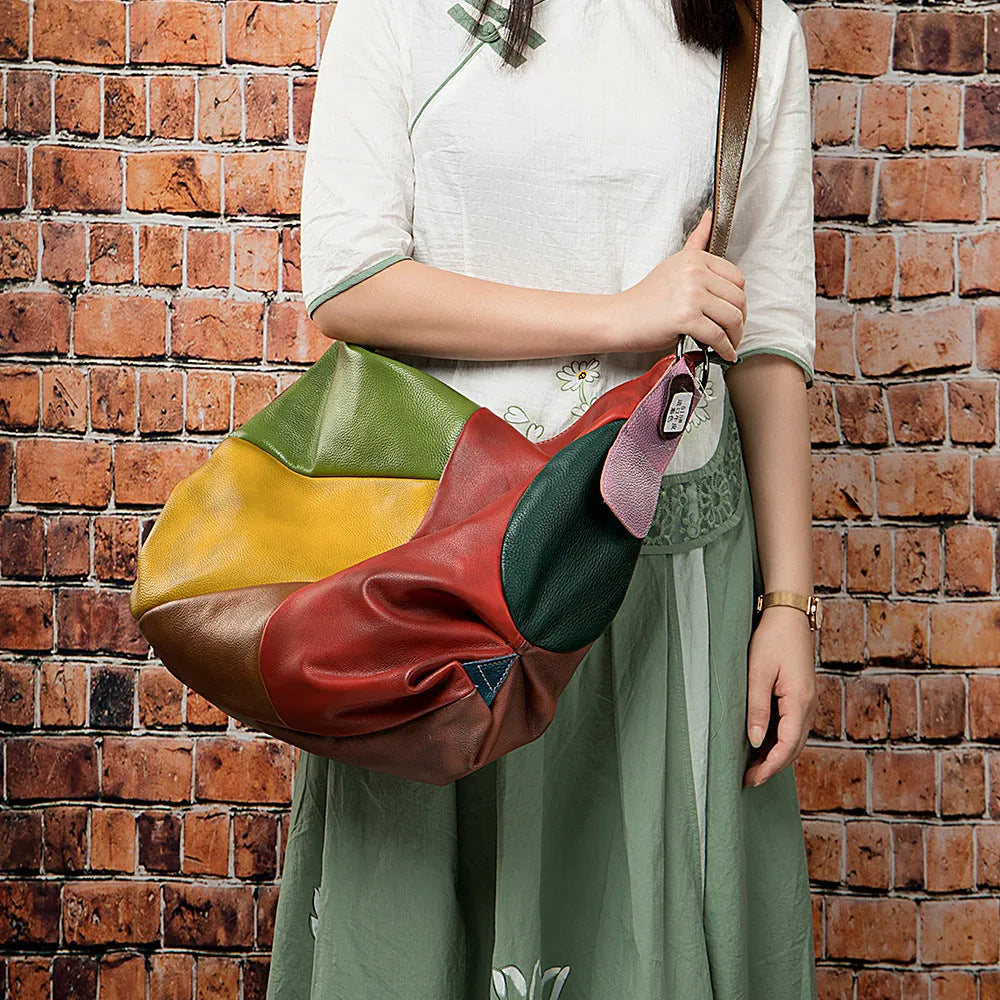 Brown cowhide leather travel bag with dimensions 48cm by 15cm by 37cm, shown as a crossbody or shoulder bag.