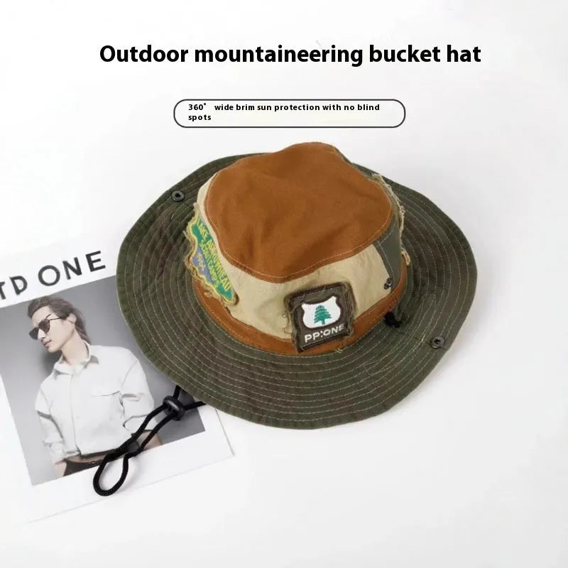 Army green cotton fisherman hat with patchwork design and flat top crown, folded to show storage feature