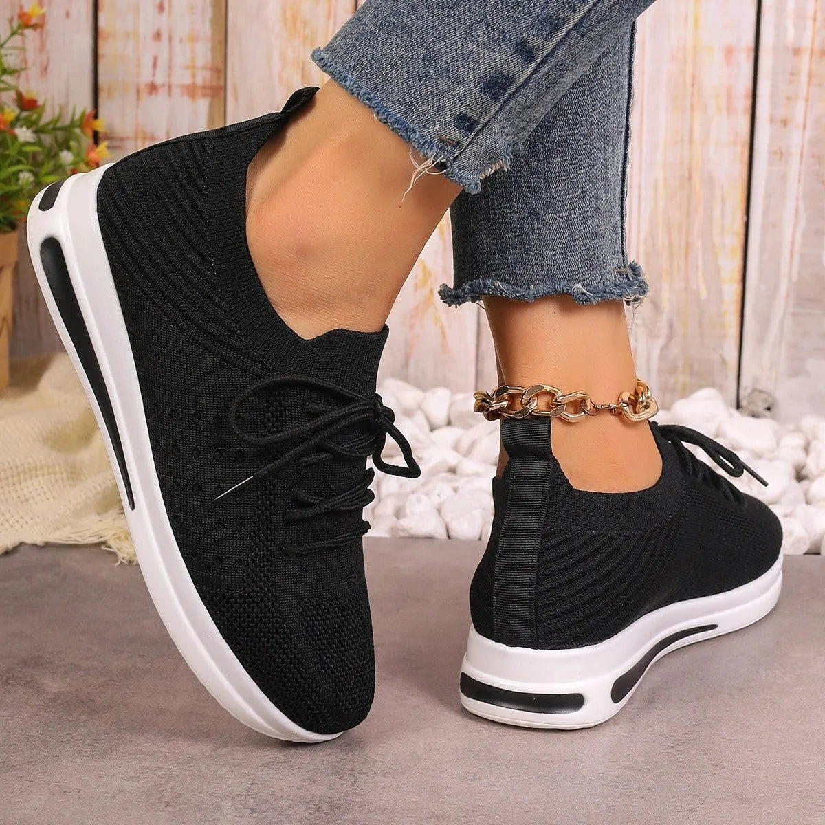 Women's fly-knit casual sneakers in solid black, blue, or red with a lace-up front and low-top design.