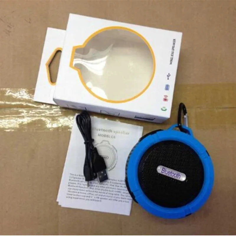 Portable waterproof Bluetooth speaker with carabiner clip in black, blue, green, red, or yellow colours