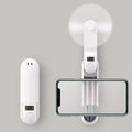 Green folding mini portable fan with USB cable on a white desk