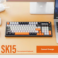 SK15 wired mechanical keyboard with control knob in Sunset Orange colour on a desk.