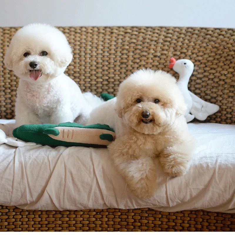 Green plush dog toy with squeaker measuring 35cm long on white background