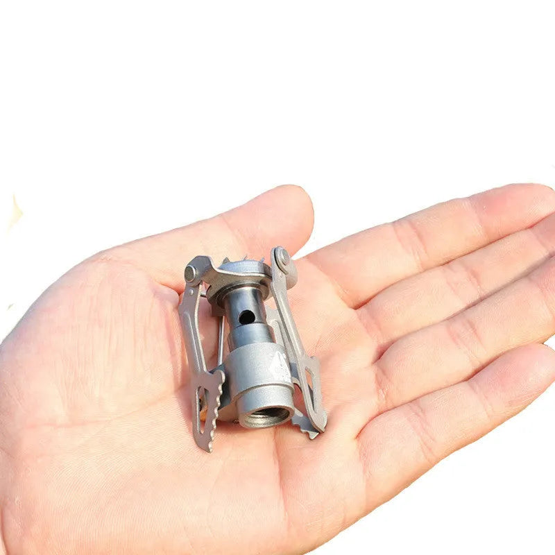 Portable propane camping stove with a one-piece metal furnace body.