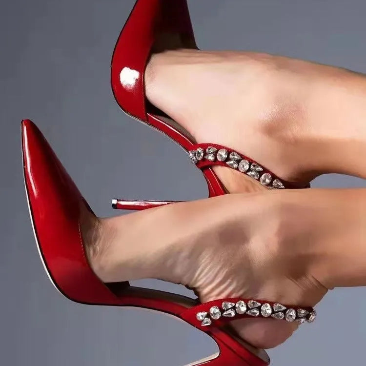 Women's pointed toe high heel sandals with rhinestone side detail on patent leather upper.