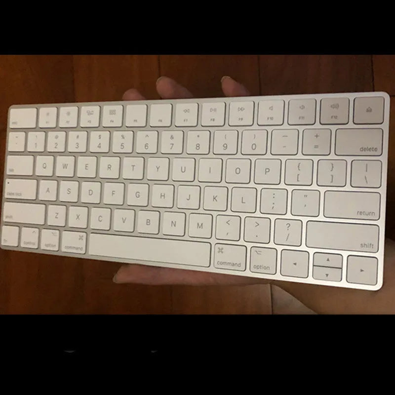 White Apple Bluetooth keyboard with ultra-thin metal design and multimedia function keys