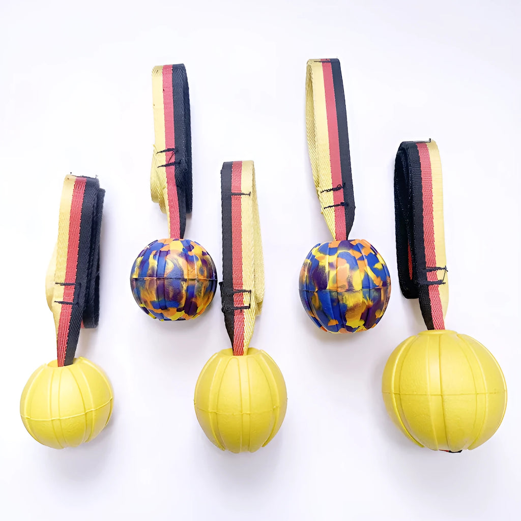 EVA floating dog training ball in camouflage colour and yellow, shown in 65mm, 7cm, and 9cm diameter sizes.