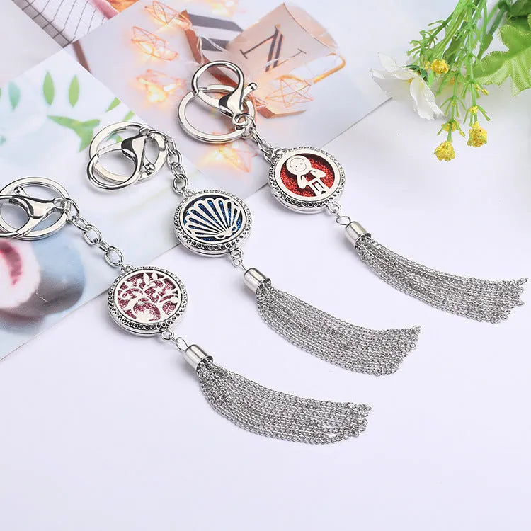 Alloy tassel car pendant with chain hanging, showing 12mm diameter fragrance compartment and coloured cotton inserts