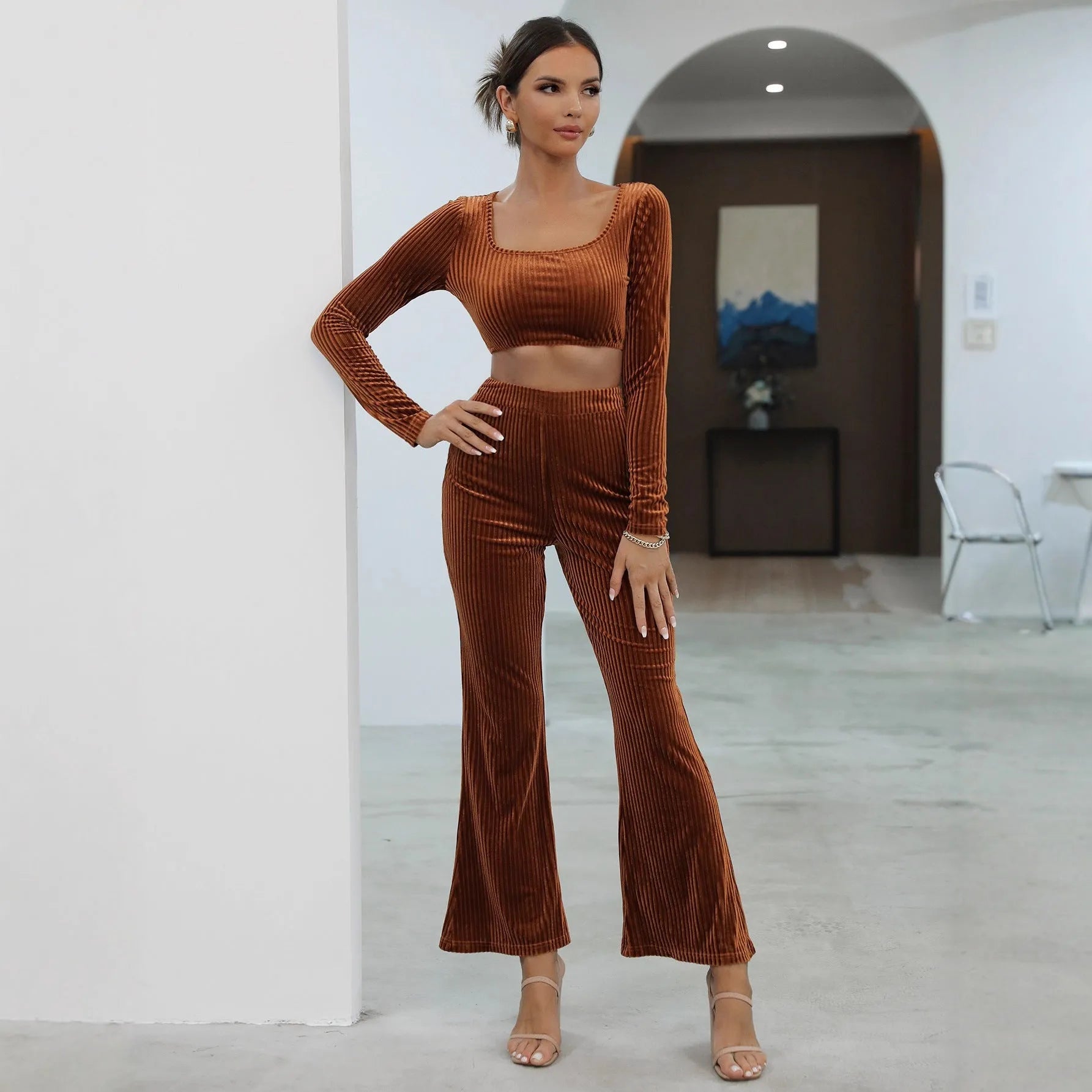 Caramel coloured long sleeve sweater and trouser casual set laid flat.