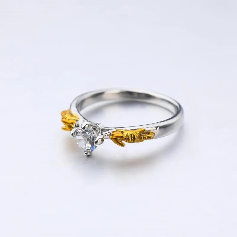 Copper crown cosplay ring with black gold finish and crystal details on a hand.