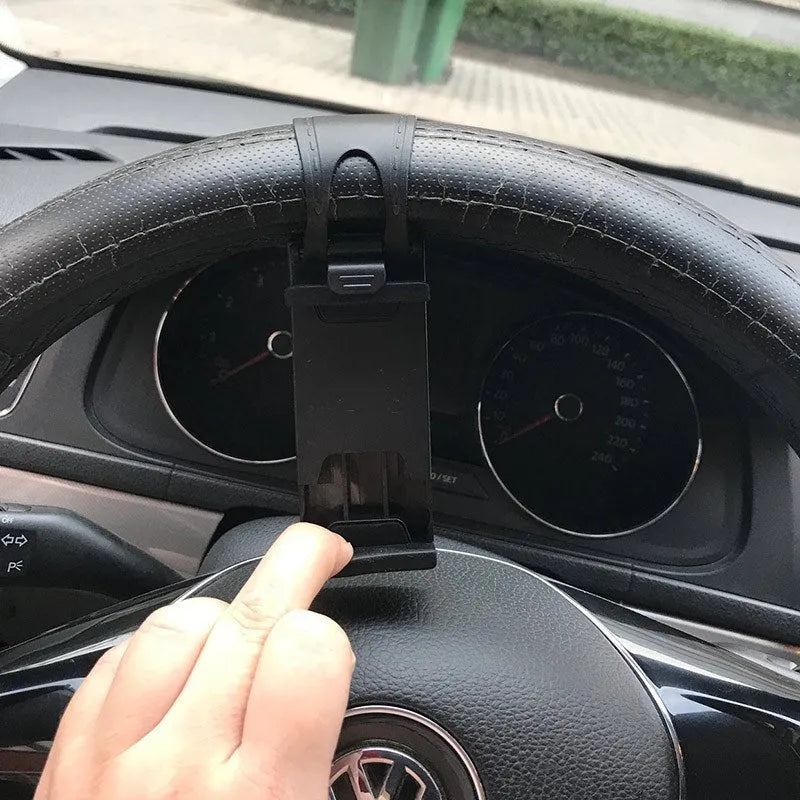 Universal black steering wheel phone mount holder clipped onto a car wheel