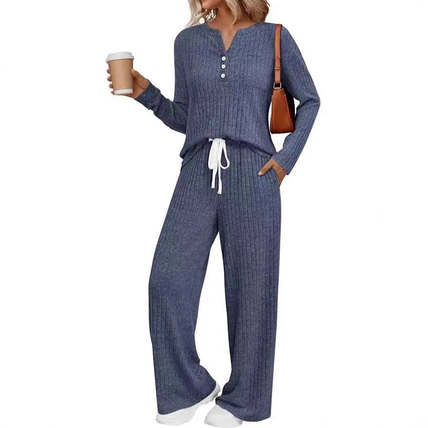 Woman wearing a striped V-neck knit long coat with lace-up detail and pants from a casual streetwear set.