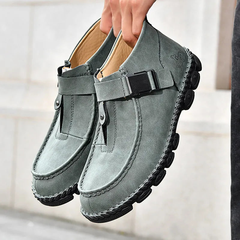 Casual black PU leather slip-on shoes with visible handmade stitching and a flat sole.