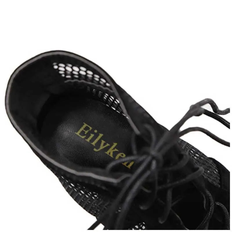 Black suede women's lace-up high heel shoe with ankle strap and 11.5cm heel.