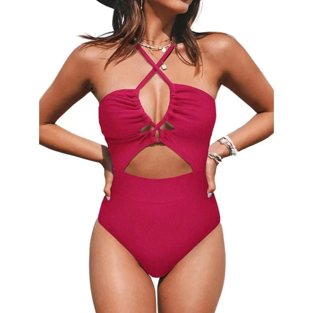Solid colour women's one-piece swimsuit with cross-back design on mannequin.
