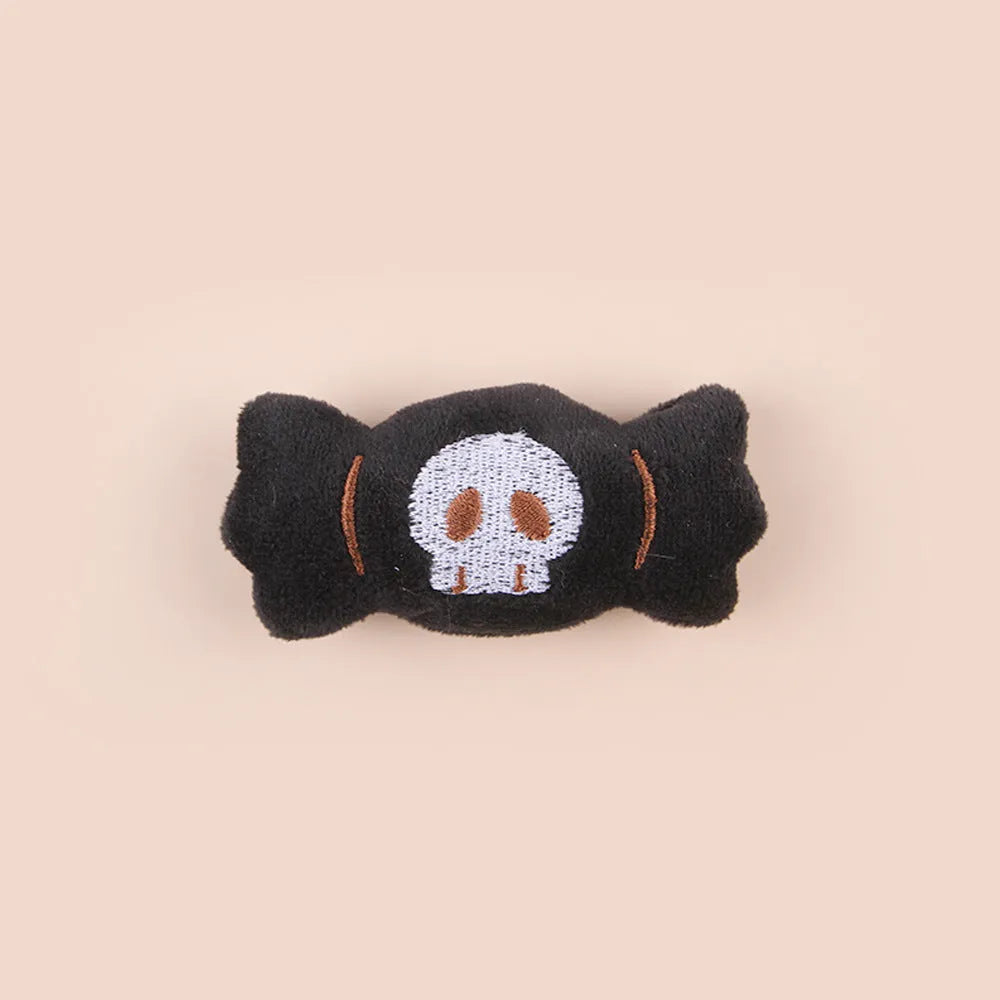 Small plush cat teaser wand with colourful eyes candy skull designs and feathers