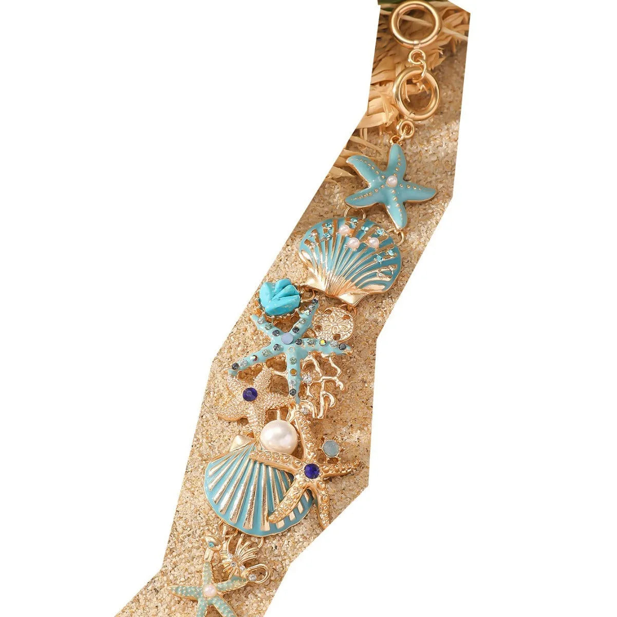 Starfish-shaped alloy bracelet with rhinestone anchor and shell details in turquoise, red, or blue.