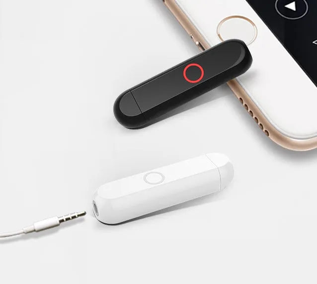 Compact black A1 Bluetooth audio receiver with 3.5mm plug shown in pendant wearing style.