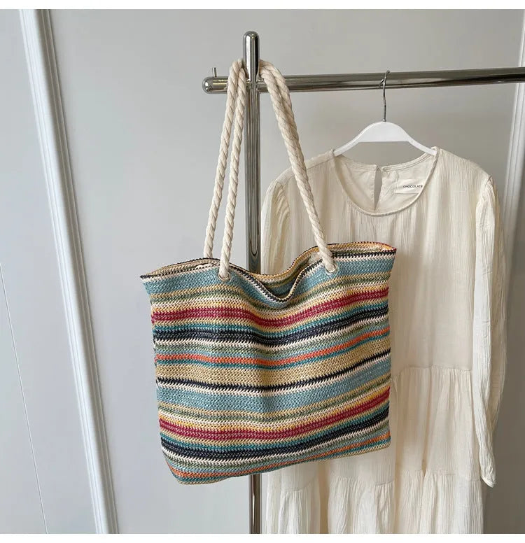 Blue straw woven nylon shoulder bag with large capacity and polyester lining.