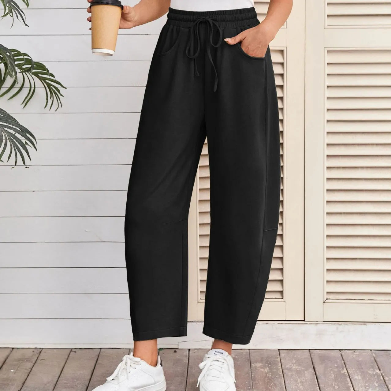 Women's loose cropped sweatpants with elastic waist and drawstring pockets in street fashion style