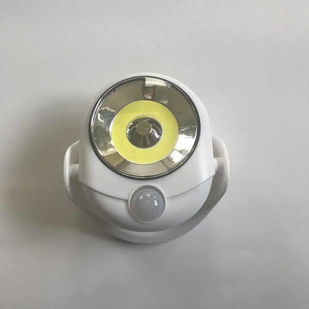 White Atomic Angel cordless induction desk lamp on a surface.