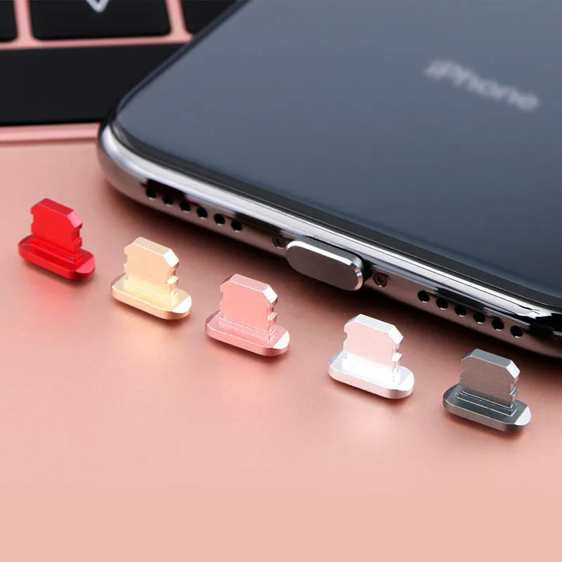 Aluminium alloy dust plug for iPhone charging port in a selection of colours including gold, silver, and rose gold.