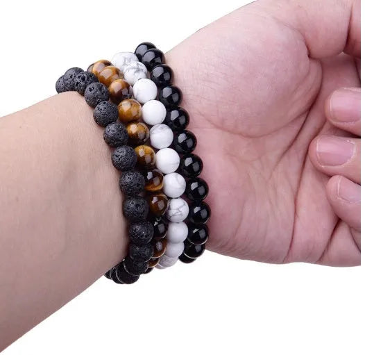 A geometric black agate bead stretch bracelet with 8mm stones on an elastic cord.