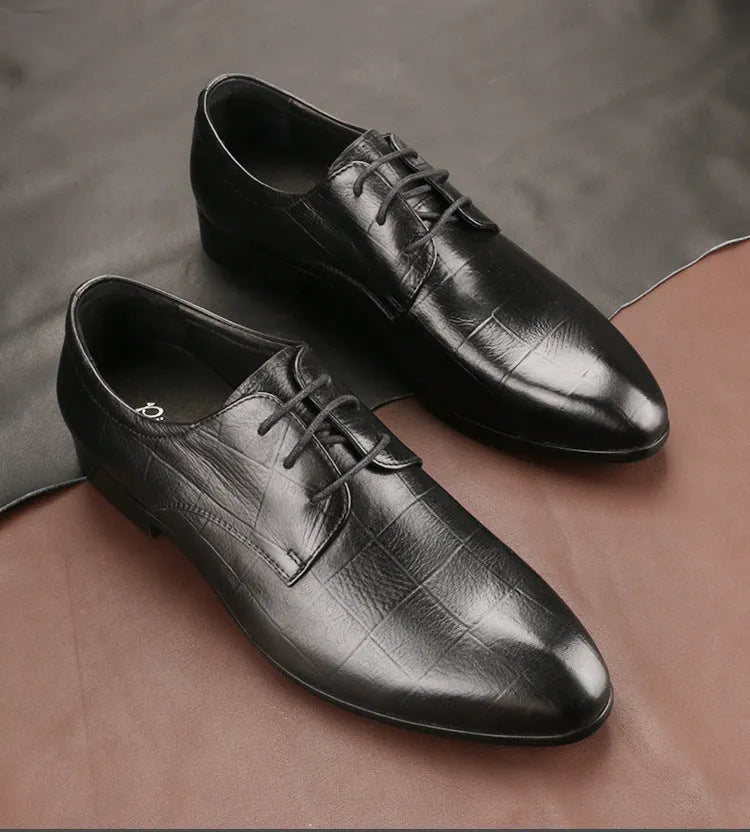 Men's black and brown checkered patterned cow leather derby shoes with pointed toe on a rubber sole.