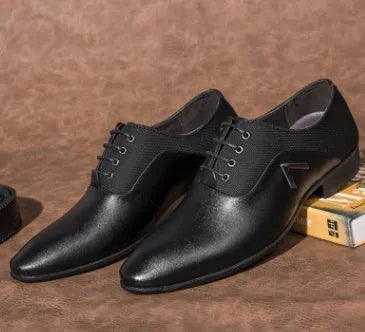 Men's black Oxford shoes with a low upper, brogue detailing, and a rubber sole.