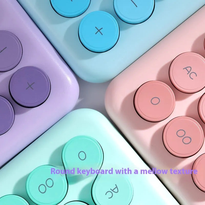 Gradient colour desk calculator in violet, cherry blossom pink, blue, or mint green on a desk.