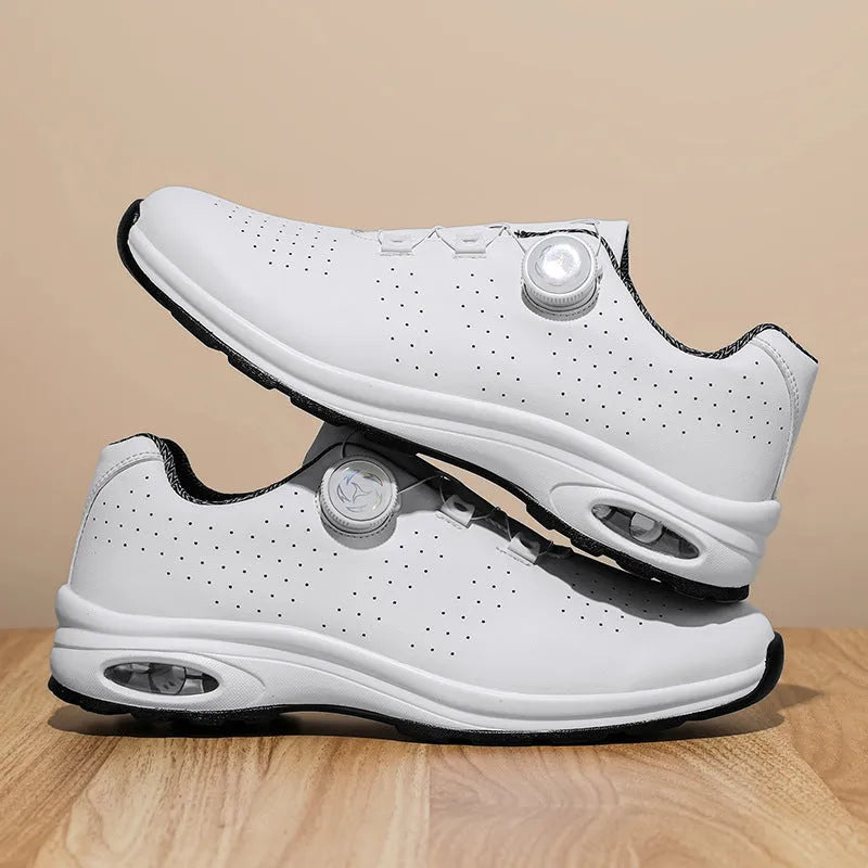 Black and white low-top casual tennis shoes with mesh upper, cross shoulder straps, and flat composite sole.