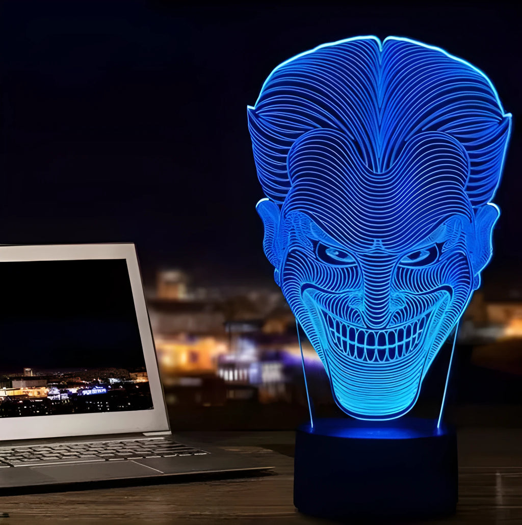A 3D LED table lamp with a colourful acrylic panel on a square base, showing multiple colour options.