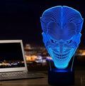 A 3D LED table lamp with a colourful acrylic panel on a square base, showing multiple colour options.