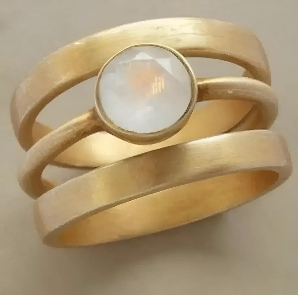 Gold-plated titanium steel ring with hollow geometric design and micro-inlaid white chalcedony.
