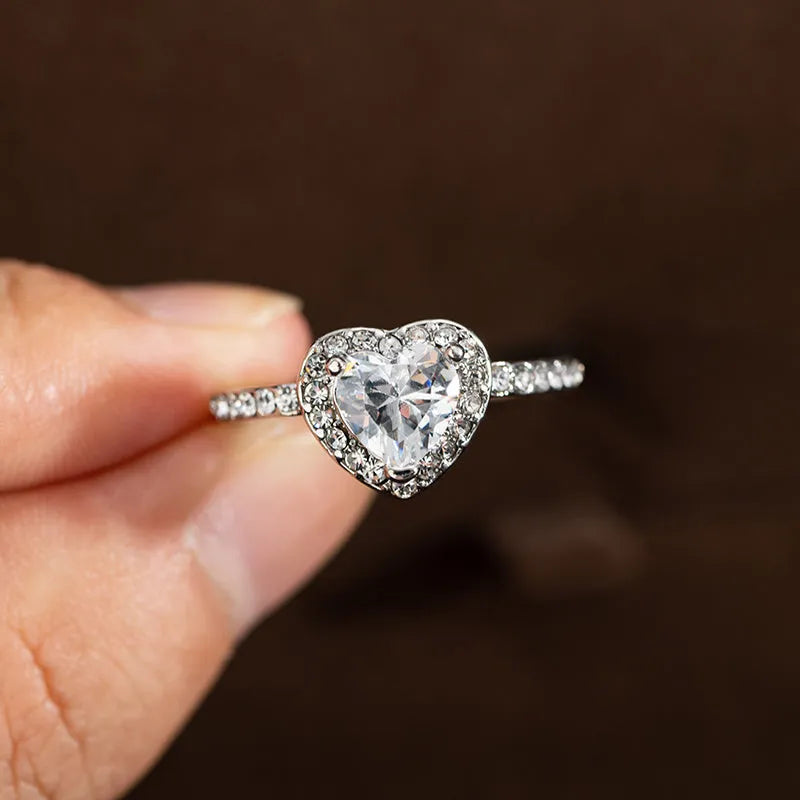 Women's heart-shaped crystal ring in rose gold or silver tone on a white background