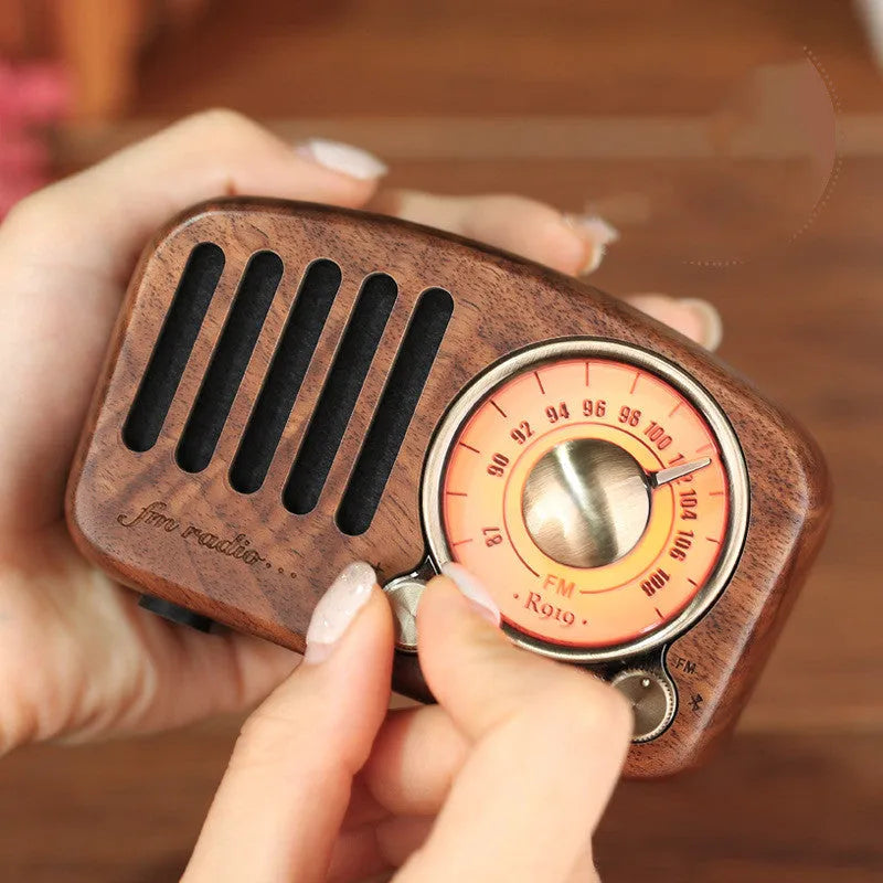 Retro wooden wireless mini speaker in cherry wood or walnut finish, showing compact size