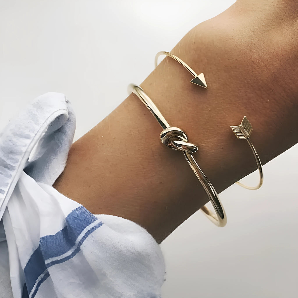 Women's vintage cuff bracelet with arrow and knotted design in gold electroplated alloy
