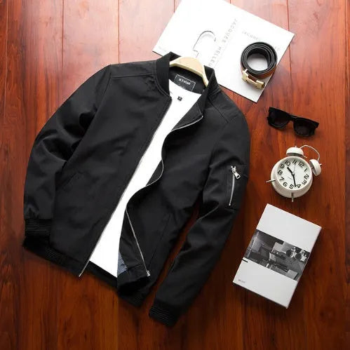 Men's slim-fit casual baseball jacket with stand collar and side zippered pockets in solid colour.