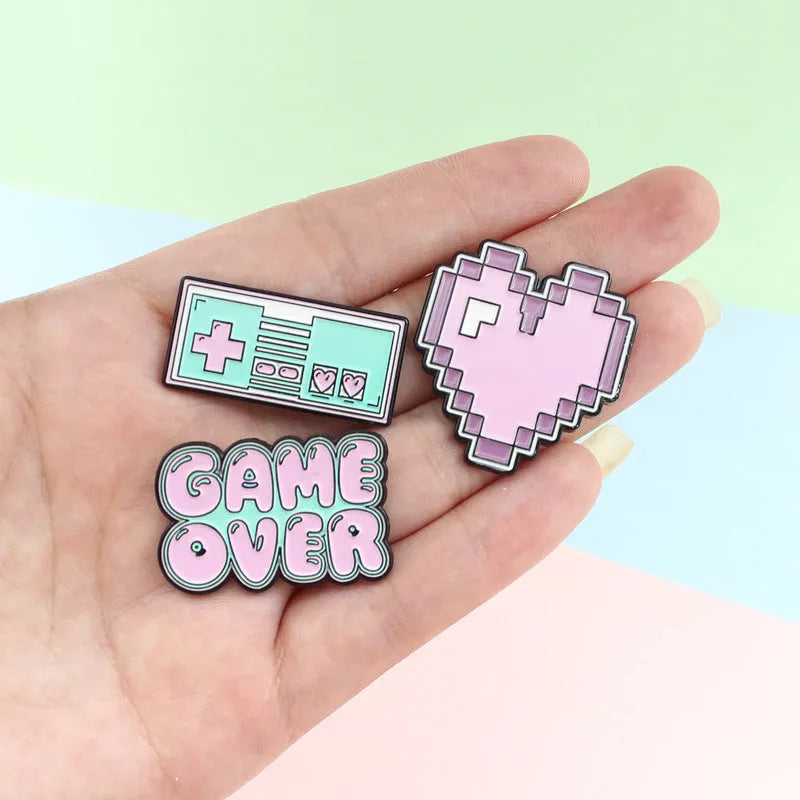 Stereo game console badge made from alloy, shown in one of three colour options with independent OPP packaging.
