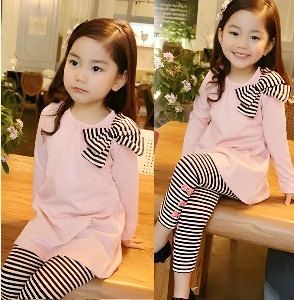 Pink cotton two-piece clothing set for a girl, shown on a hanger.