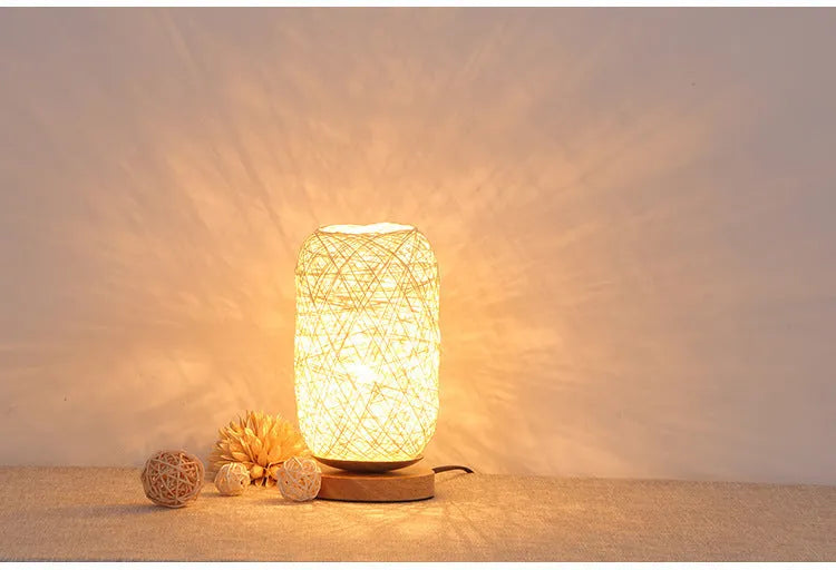 Sepak Takraw ball design desk lamp made of brown hemp rope and wood with a warm LED light.