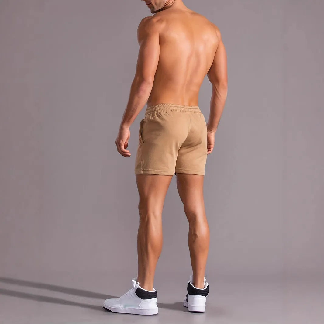 Men's khaki sports shorts with coconut palm leaf print, elastic waistband, straight cut design