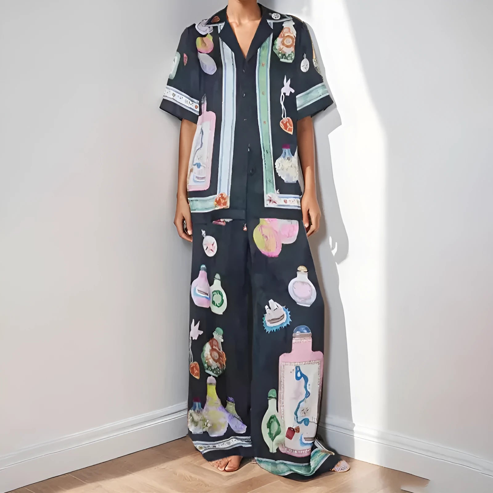 Black women's cardigan and pants set with cartoon animation print.