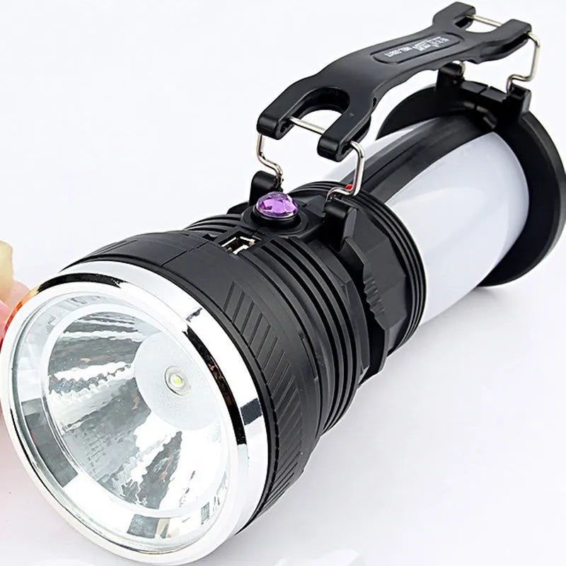 Black solar-powered and USB-rechargeable LED emergency flashlight with press switch.