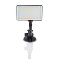 Black aluminium USB LED conference light with screen, shown next to a laptop for video calls.