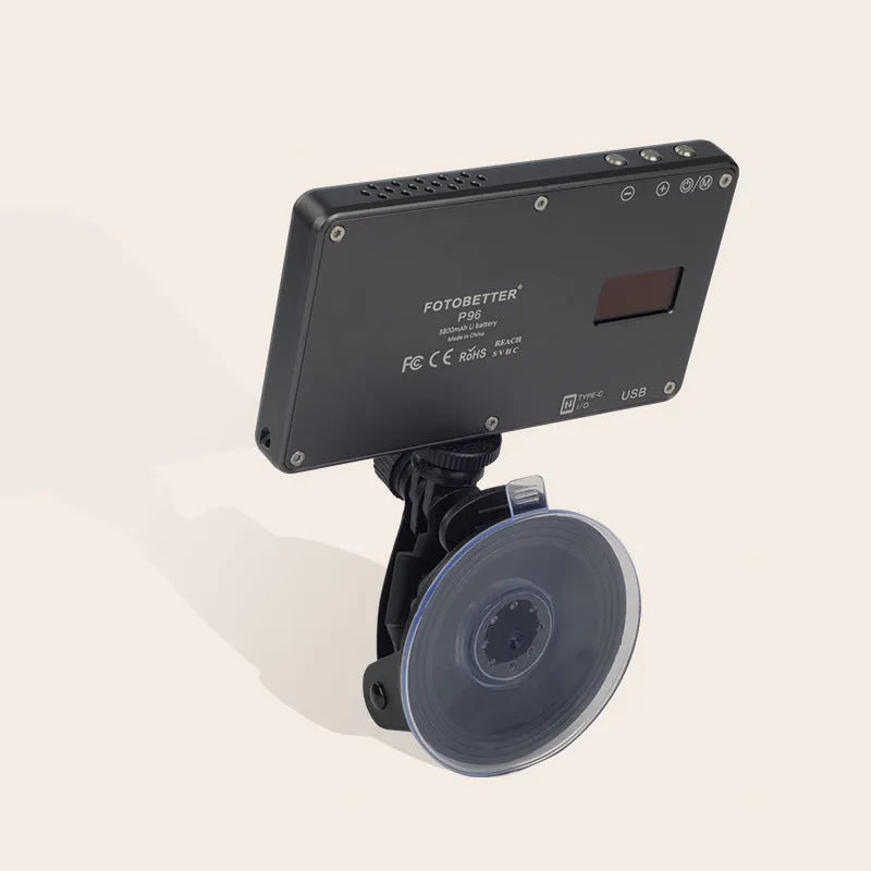 Black aluminium USB LED conference light with screen, shown next to a laptop for video calls.
