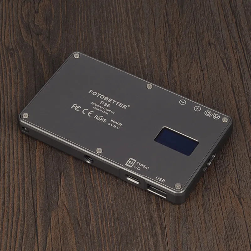 Black aluminium USB LED conference light with screen, shown next to a laptop for video calls.