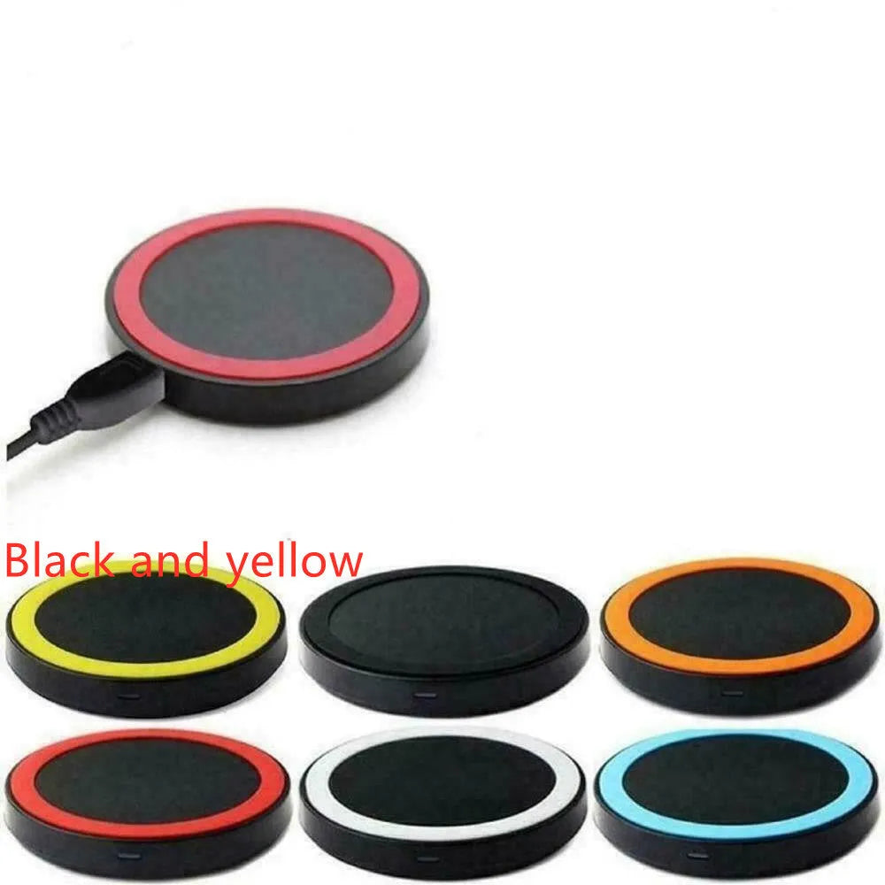 Slim square Qi wireless charging pad in one of six colours on a desk next to a mobile phone.