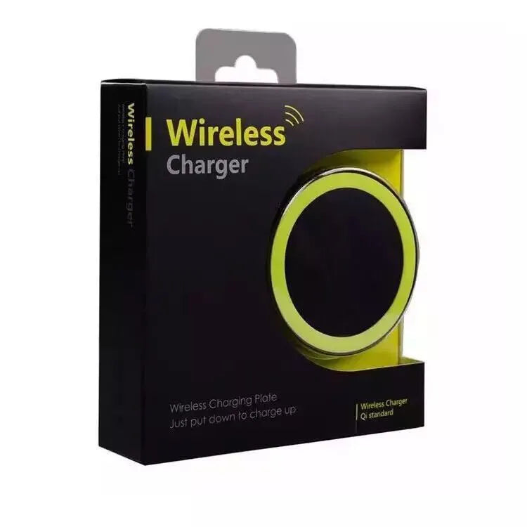 Slim square Qi wireless charging pad in one of six colours on a desk next to a mobile phone.