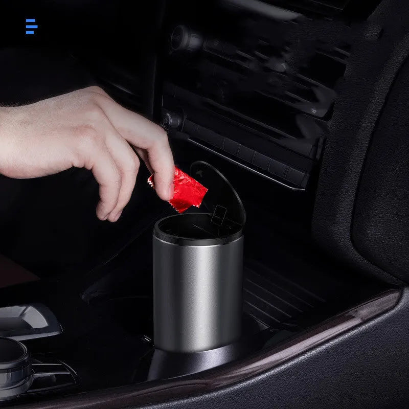 Alloy car trash bin in black with click-open lid placed in cup holder